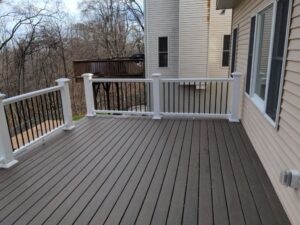 Our carpenters remodeled this deck with composite decking, vinyl railings and iron balusters. Our deck building company serves homes in Morris County, New Jersey.